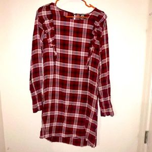 Plaid dress with ruffles at the shoulders.